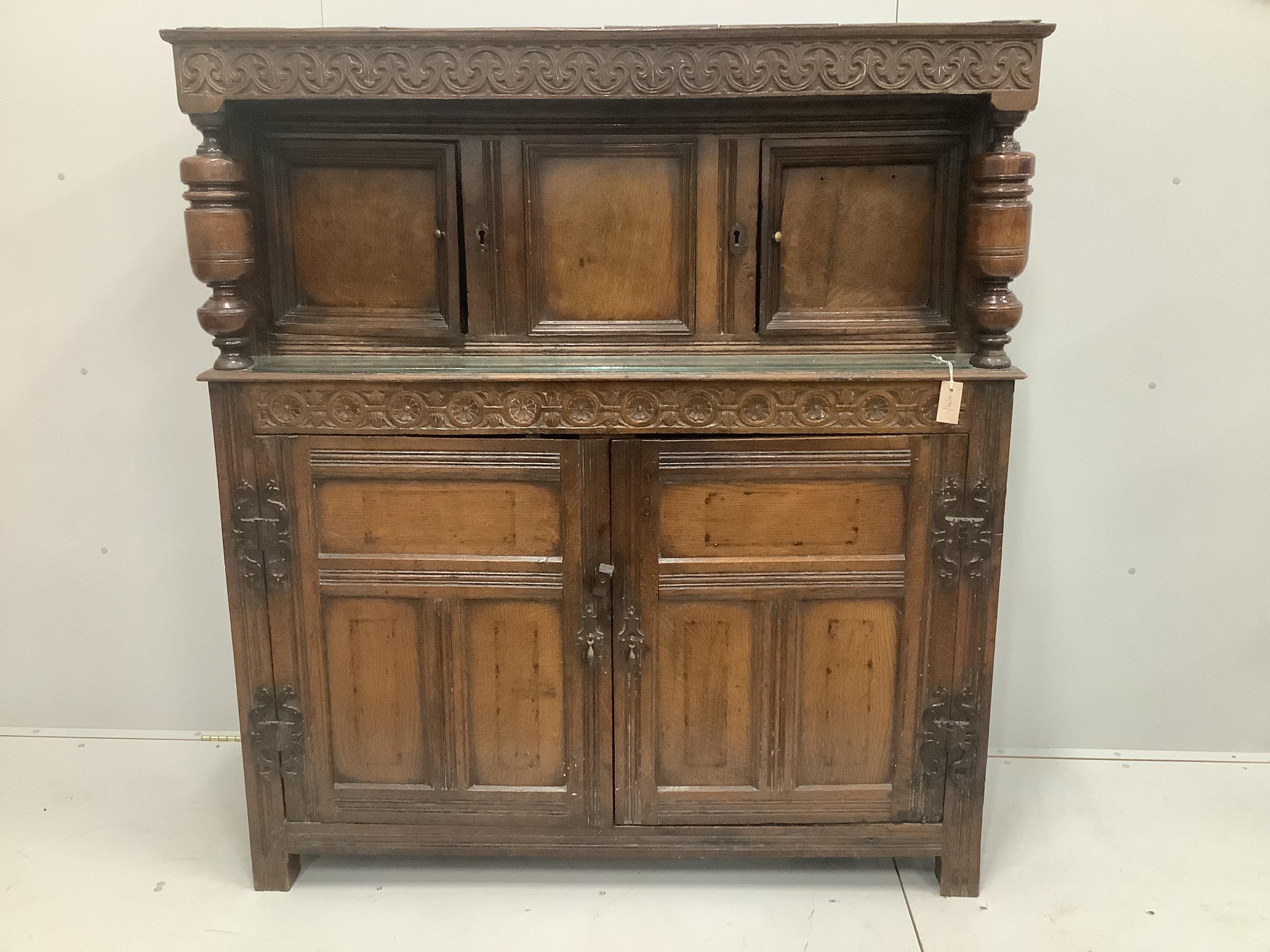 A 17th century and later carved oak court cupboard, width 141cm, depth 51cm, height 157cm